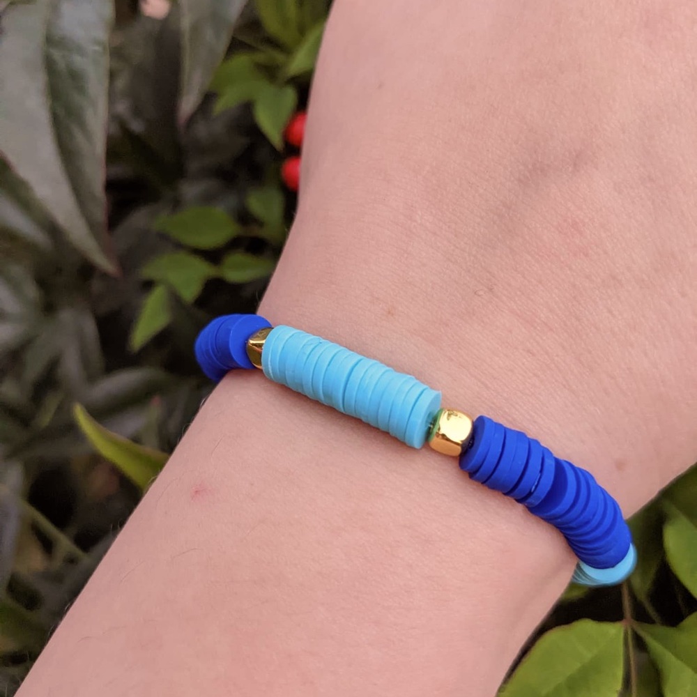 This clay bead bracelet with is made with blue,light blue and gold clay beads.